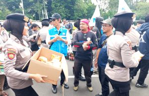 Polwan Polda Metro Jaya Bagikan Roti dan Air Mineral ke Massa Aksi Buruh di Gambir